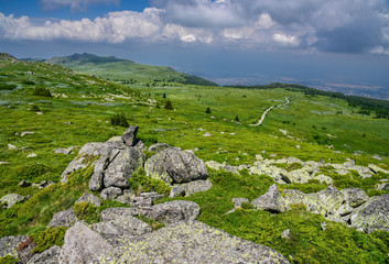 Fototapeta na wymiar Path through the mountains at Vitosha, Sofia, Bulgaria - popular Bulgarian tourist destination with blue skies and amazing scenery
