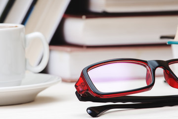 Books stacked glasses on the table