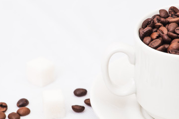 Coffee beans with white cup of coffee