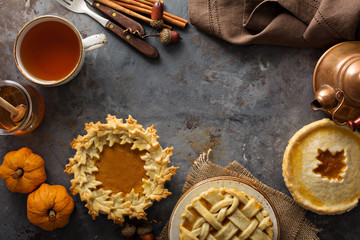 Homemade pumpkin pies decorated with fall leaves