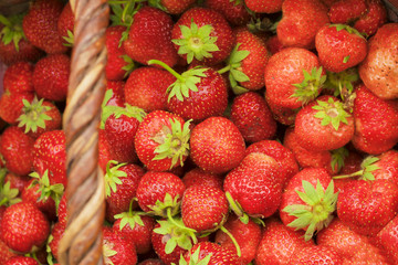 Ripe red strawberries in a basket, background
