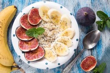healthy breakfast: oatmeal with fresh figs, bananas,  coconut mi