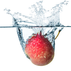 Apple in water splash, isolated in white background