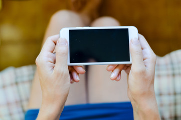 Beautiful young lady using smartphone