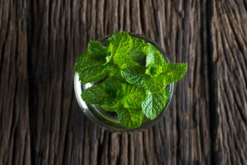 Fresh mint on wooden table copy space. Selective focus.