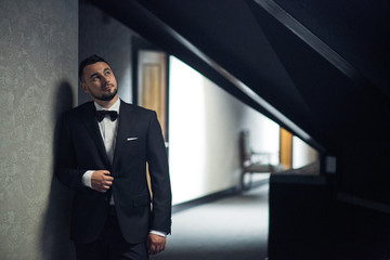 Portrait of the groom in the luxury black suit