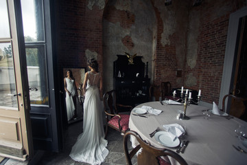 Bride in the amazing dress surrounded with the decoration
