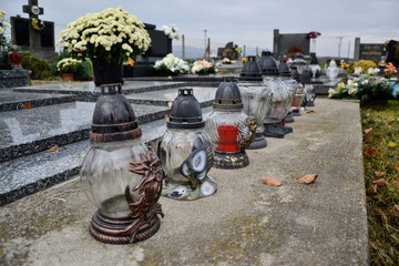 Votive candles lantern on the grave in Slovak cemetery. All Saints' Day. Solemnity of All Saints. All Hallows eve. 1st November. Feast of All Saints. Hallowmas. All Souls' Day