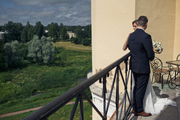 Groom with his bride on the nice balcony