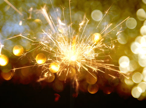 Sparkler On Gold Bokeh Background Macro Close Up