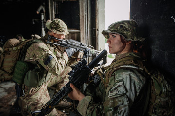 Soldiers on patrol in destroyed city. Military and rescue operation