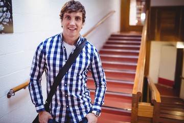 Fototapeta premium Student standing near staircase