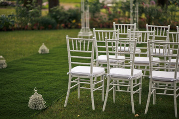 Well-prepared white chairs in the lovely park
