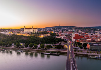 Night view of Bratislava city center with Cathedral, historical buildings, and traffic. Beautiful travel picture of Slovakia.