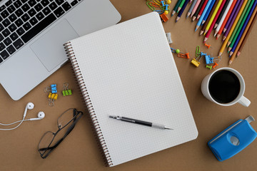 Notebook and laptop on desk