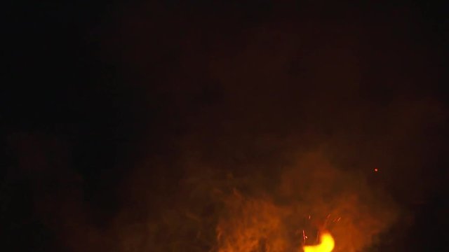 fire sparks from campfire over black background