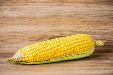 fresh corn on wooden table background.