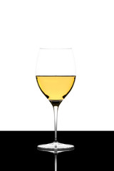 white wine glass on a  black board isolated and backlit and refl