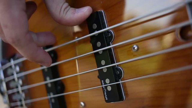 Bass guitar player close up playing virtuoso bass with fingers