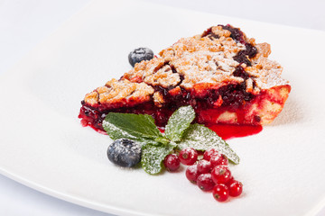 Sandy dough cake with jam and berries