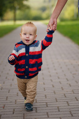mother holding son by hand