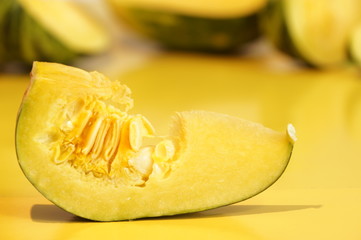 Yellow and ripe pumpkin lie on a bright background
