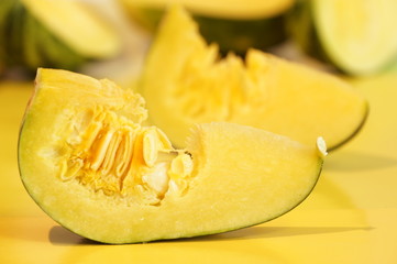 Yellow and ripe pumpkin lie on a bright background