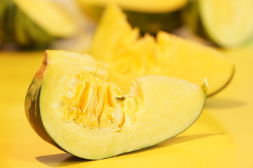 Yellow and ripe pumpkin lie on a bright background