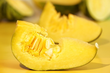 Yellow and ripe pumpkin lie on a bright background