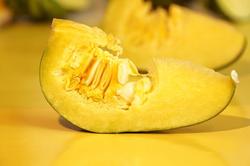 Yellow and ripe pumpkin lie on a bright background