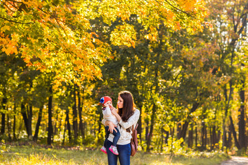 Mother and daughter in the autumn park