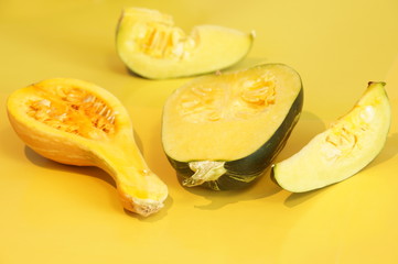 Yellow and ripe pumpkin lie on a bright background
