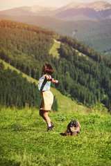 beautiful happy girl dressed in country style sitting on mountain high