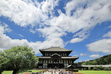Naklejka premium Student enjoy the field trip at Todiji temple in bright sky day. The Daibutsuden is the world's largest wooden building ,Nara, Japan.
