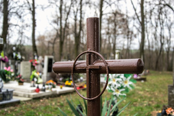 Iron cross grave in the Slovak cemetery. Metal cross on graveyard