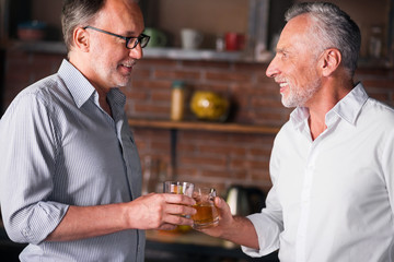 Happy male friends meeting after long time