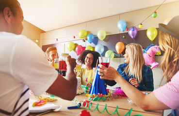 Coworkers laughing during a birthday party - obrazy, fototapety, plakaty