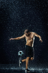 Obraz na płótnie Canvas Water drops around football player under water
