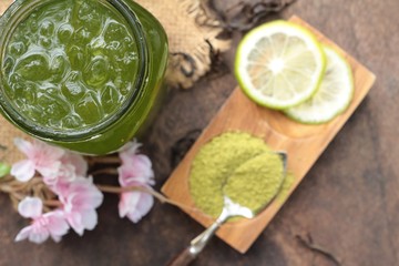 Iced green tea with lemon and matcha tea powder.