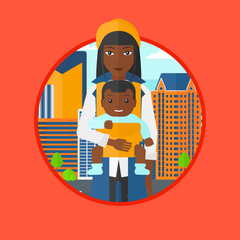 Mother carrying her son in sling.