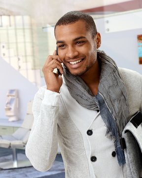 Trendy afro american man talking on mobile phone