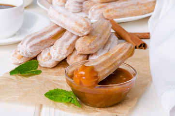 Baked churros with cinnamon, powdered sugar, chocolate and caramel sauce