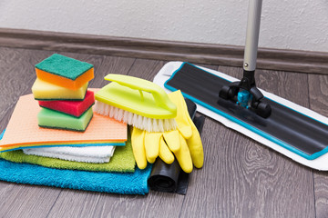 house cleaning equipment and accessories on the laminate floor - obrazy, fototapety, plakaty