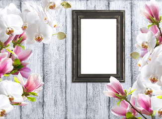 Magnolia flowers with orchidea and photo frame
