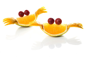 Food art creative concepts. Cute crab made tangerines and grapes isolated on white background