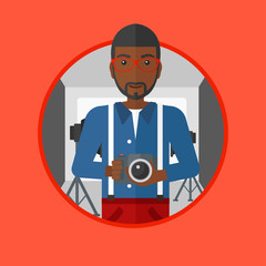Photographer with camera in photo studio.