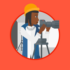 Photographer working with camera on tripod.