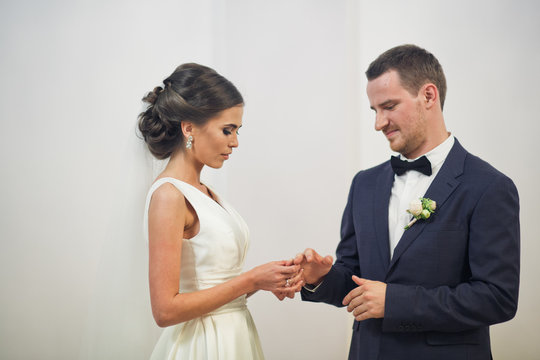 The groom wears a wedding ring