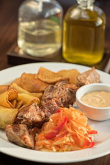 Grilled pork, baked potatoes and vegetable