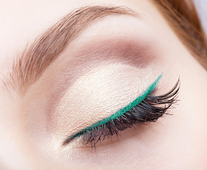 female face makeup with closed eye and green eyeliner - obrazy, fototapety, plakaty